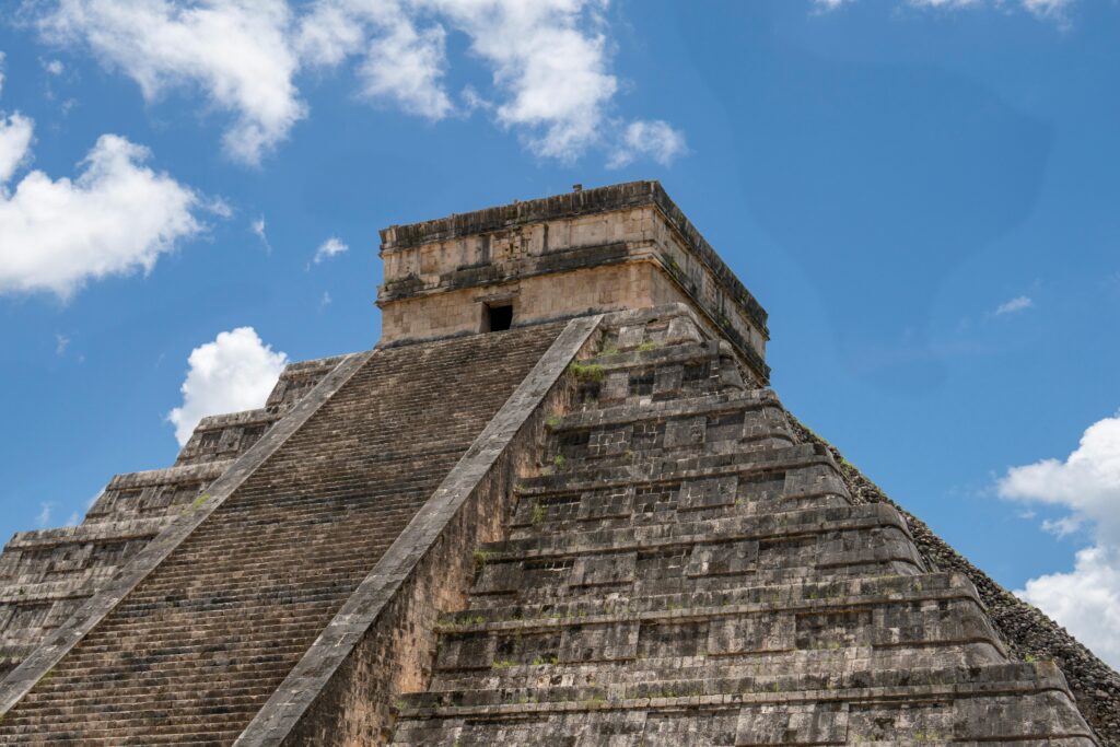 pexels photo 28121859 28121859 Explore the iconic stepped pyramid of Chichén Itzá against a bright blue sky.
