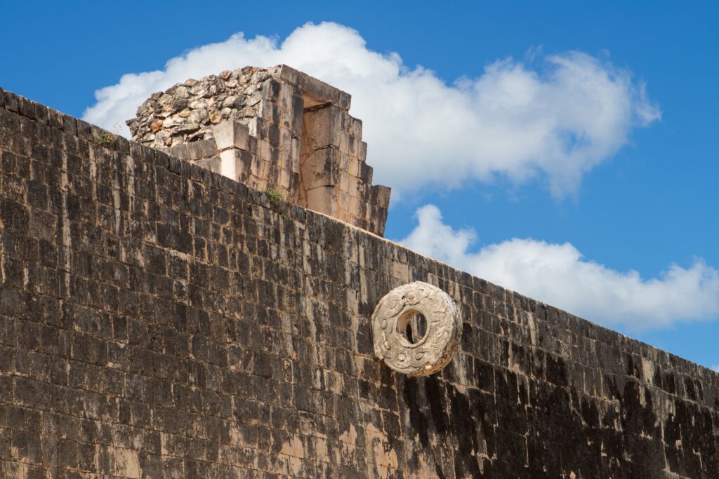 pexels photo 28278494 28278494 Explore the ancient Mayan ballcourt at Chichen Itza under a vibrant blue sky.