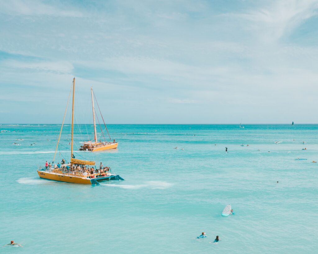 pexels photo 4319841 4319841 Two catamarans sail on turquoise waters in Hawaii, offering a picturesque ocean adventure.